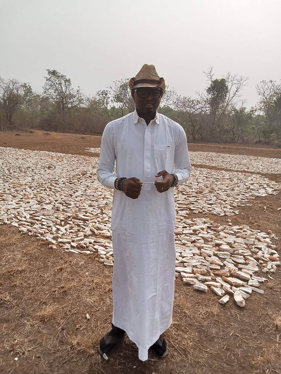 Standing on the drying field among cassava chips
